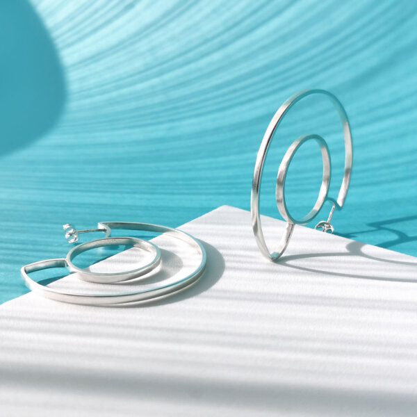 Silver earrings formed from circle and one semi-circle